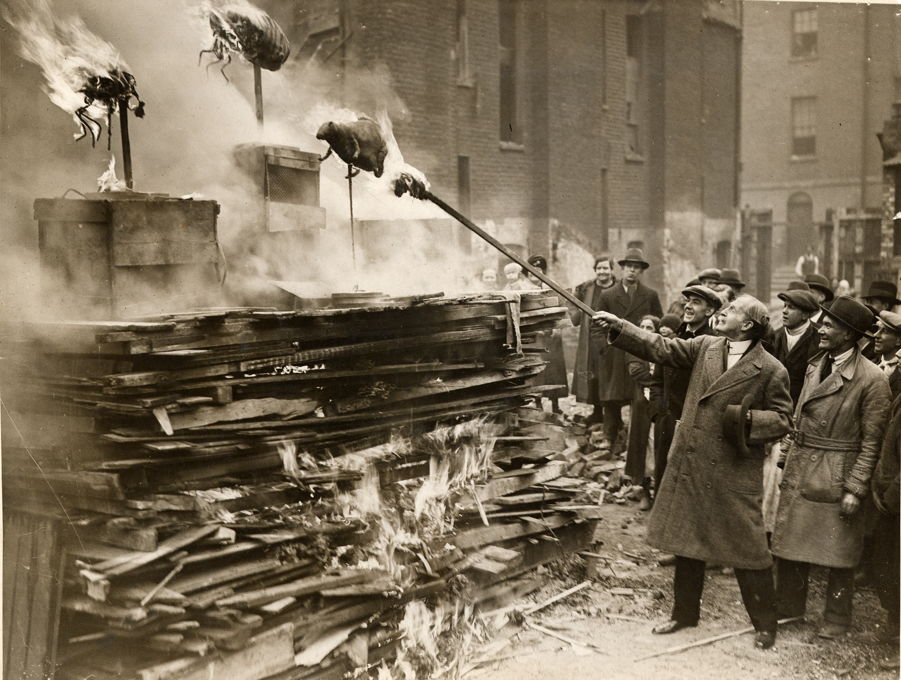 Ceremonial burning of models of bugs at the opening of St Christopher’s Flats in Somers Town in 1931 